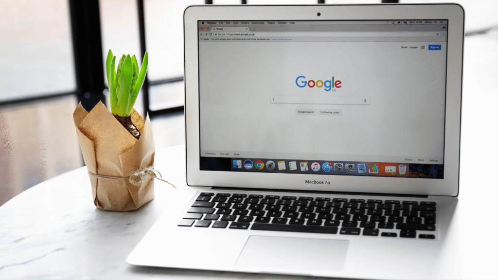 A MacBook laptop displaying the Google search homepage, representing the importance of SEO for getting a new website ranked and visible.