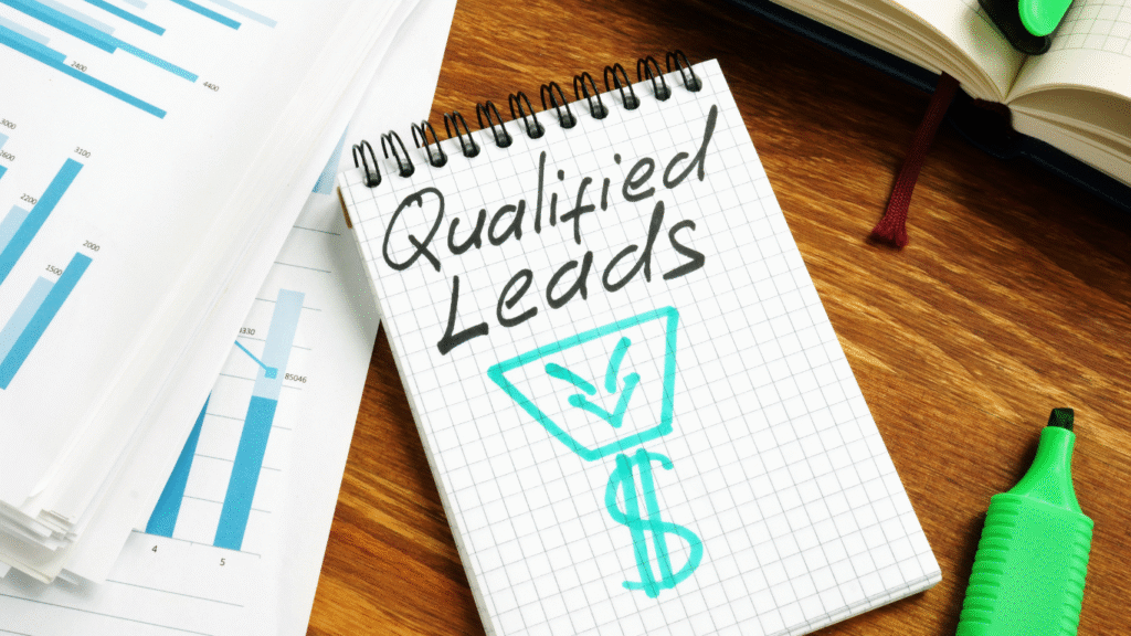 A notebook with 'Qualified Leads' written above a funnel and dollar sign, symbolizing the importance of filtering marketing leads for higher profitability.
