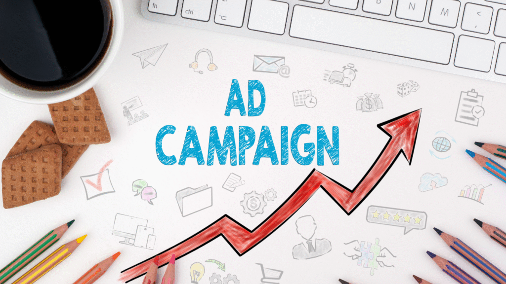 A creative desk setup with "AD CAMPAIGN" and a rising red arrow, symbolizing growth and success in Google Ads campaigns, surrounded by marketing icons.