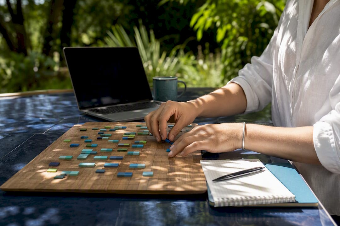 Hands arranging calendar tiles on scheduling board