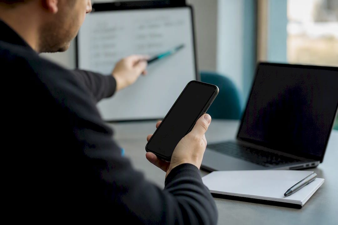 Hands verifying business phone numbers in office