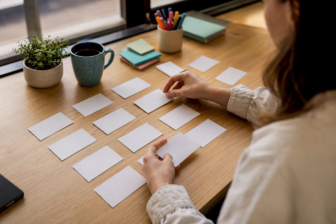 Hands arranging competitor ad theme cards